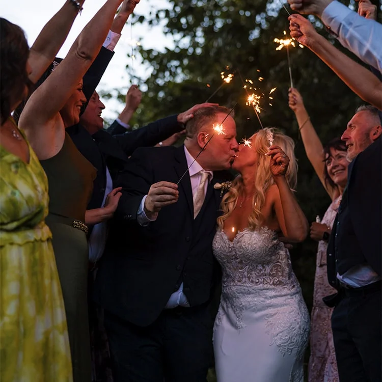 A bride and groom kiss underneath a sparkle at Clontarf Castle Wedding Venue in Dublin.